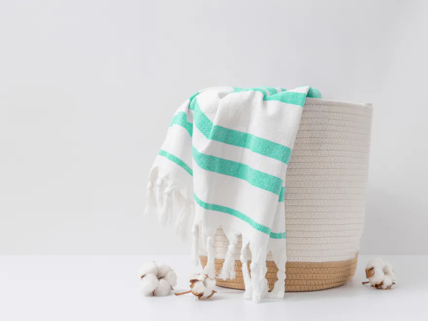 Striped towel in a woven basket